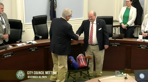 Video thumbnail of City Council meeting on 12/10/2025, with Mayor elect Shanahan shaking hands with outgoing Mayor Carrier