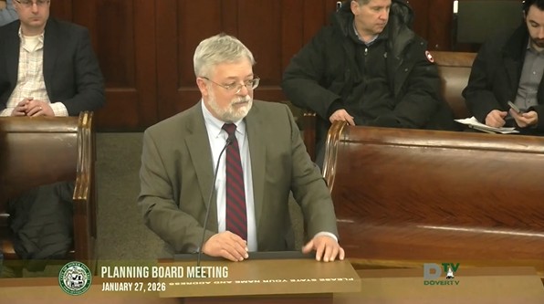 Video thumbnail of Planning Board meeting on 1/27/26, with a man in a suit speaking from the podium