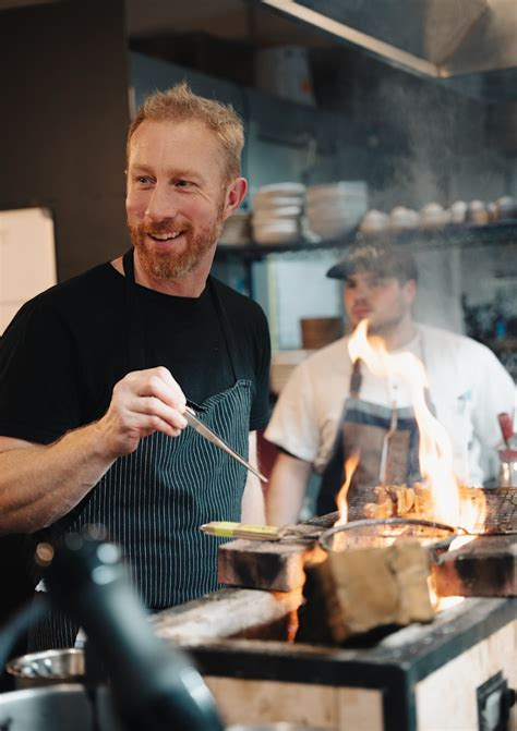 Chef Evan Hennessey works the grill in kitchen